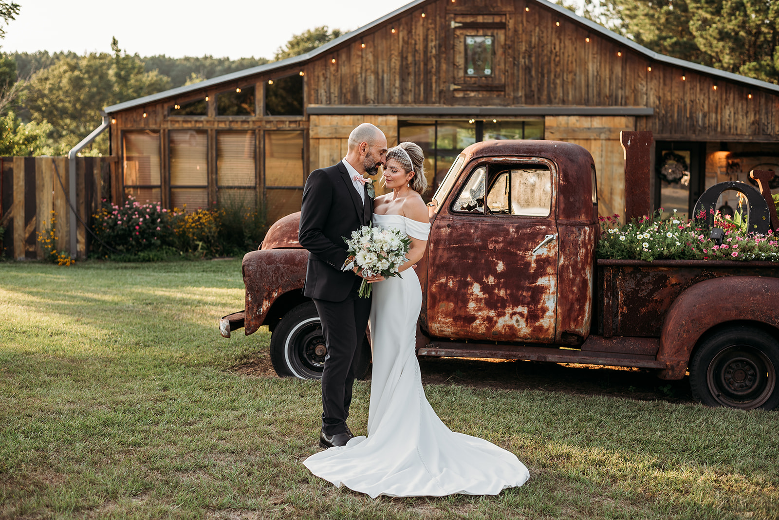 bride and groom portrait in front of wedding venue